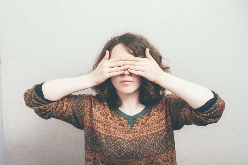 woman covering her eyes