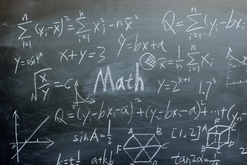 Math text with some maths formulas on chalkboard background.
