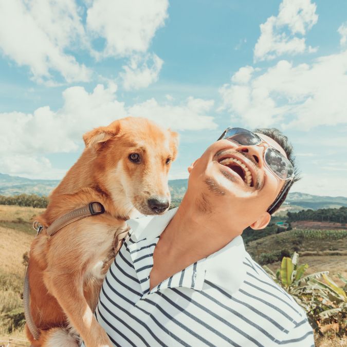 a happy man with his dog