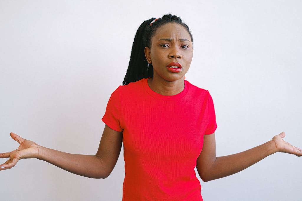 Black woman red shirt confused Lost in Translation: 13 Phrases from the Past That Confuse Millennials