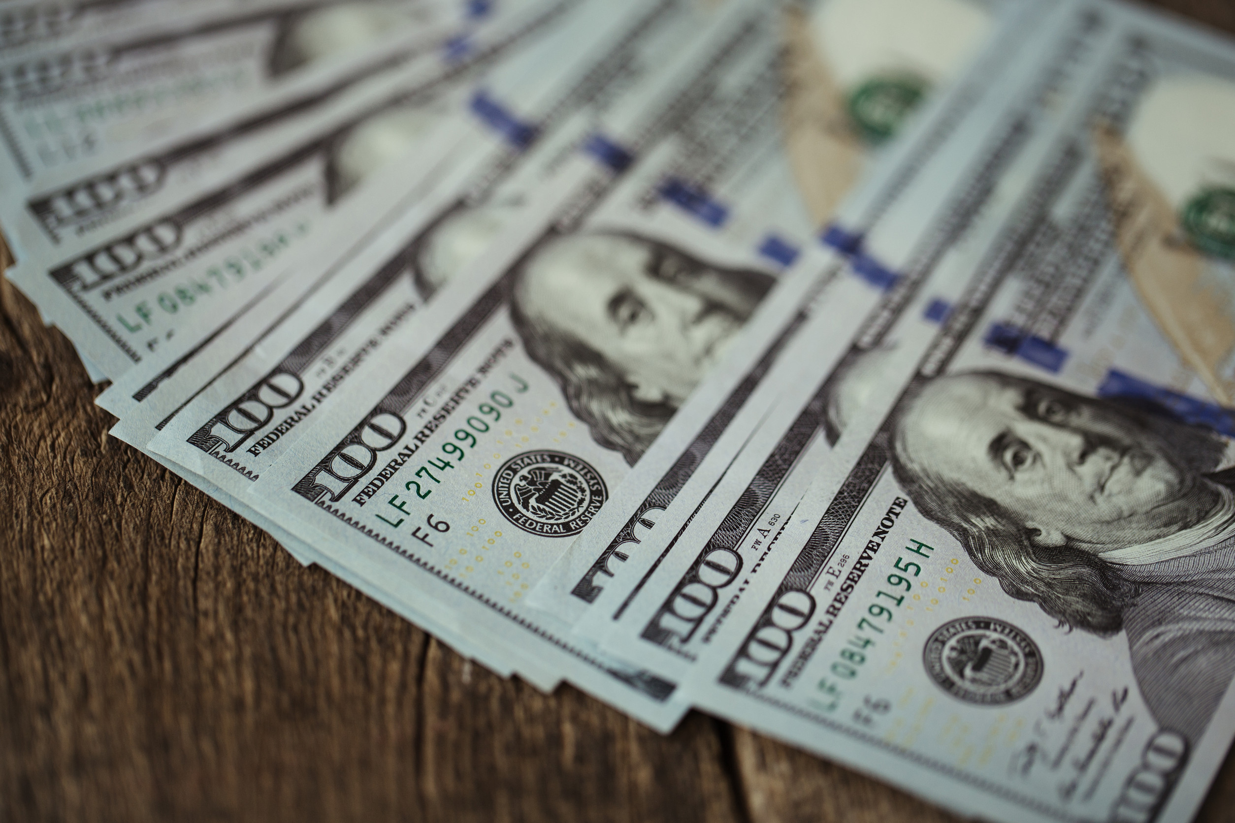 American dollar money bills spread on old wooden background