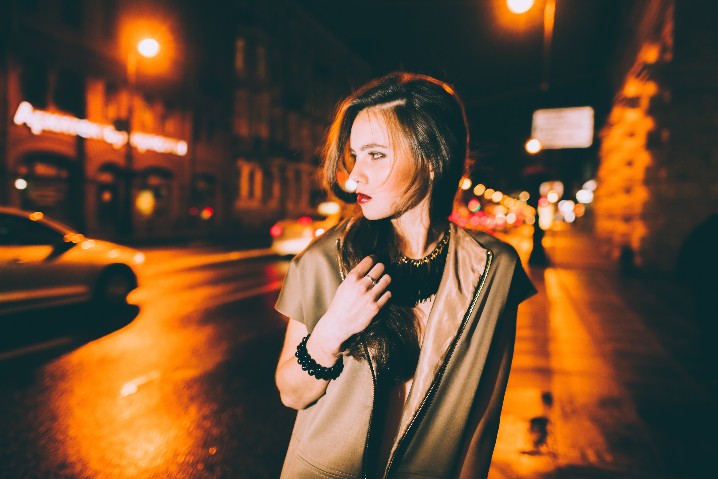 Sexy gorgeous brunette girl portrait in night city lights. Motion effect.