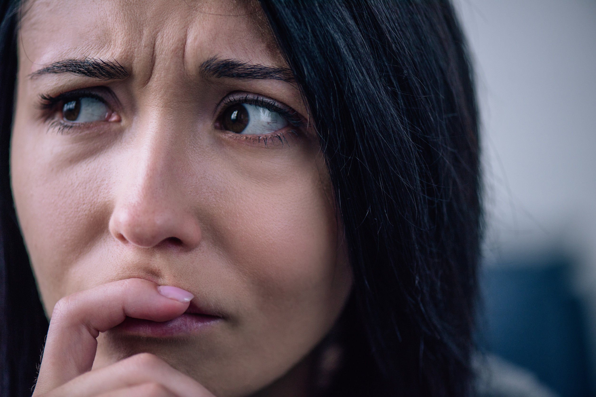 beautiful upset woman covering mouth at home and looking away