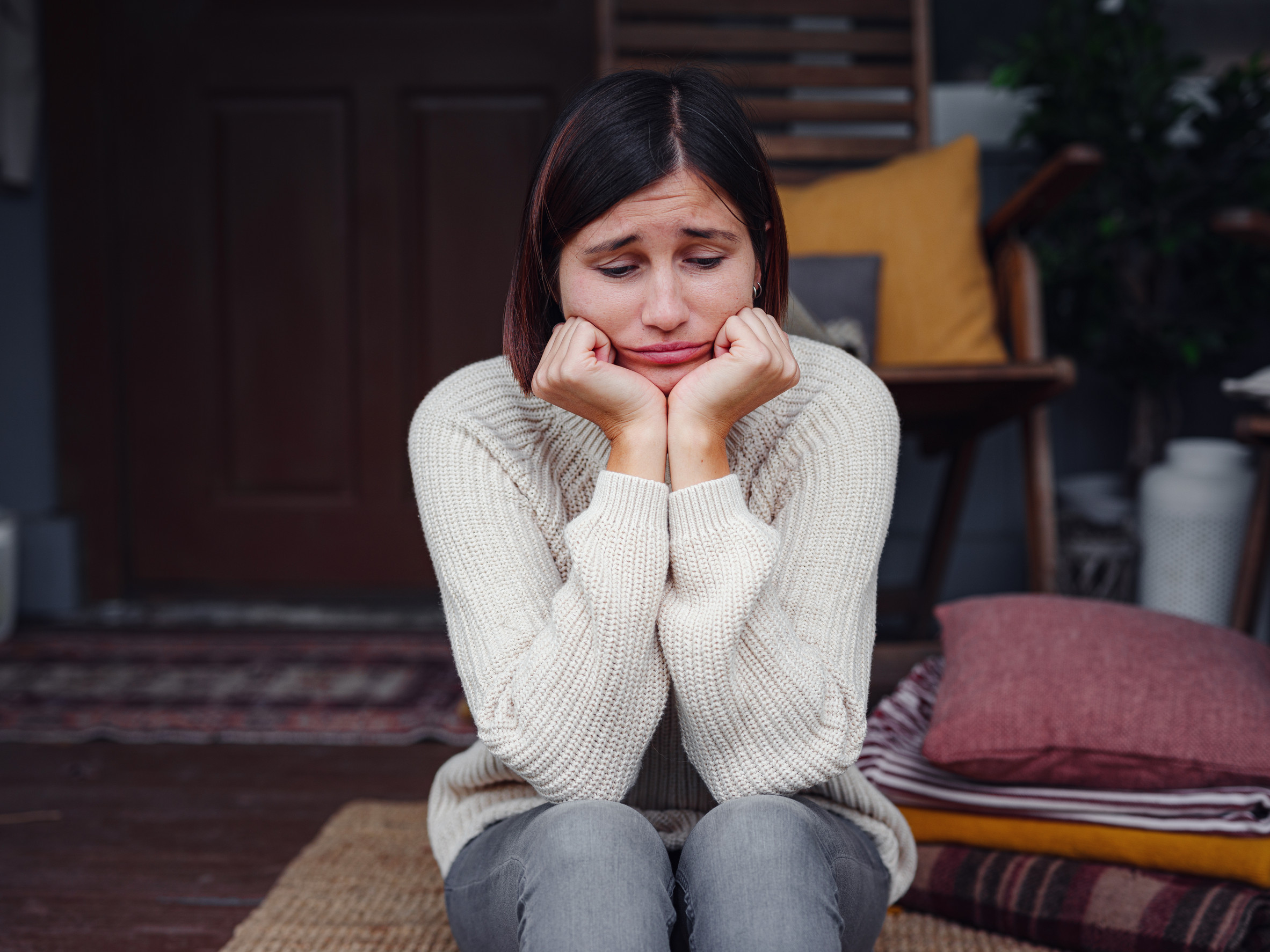Young depressed asian woman sitting on porch of backyard. She feeling sad and worried suffering depression in mental health. Mental health, anxiety depressed thinking chinese lady.