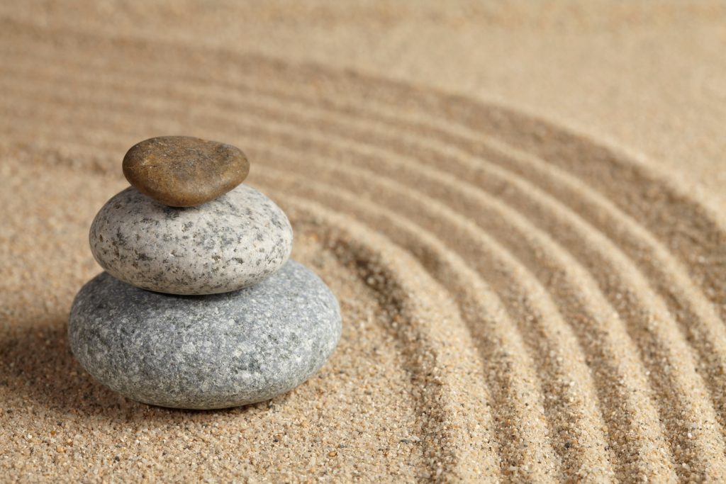 Three stones stacked up in rock garden