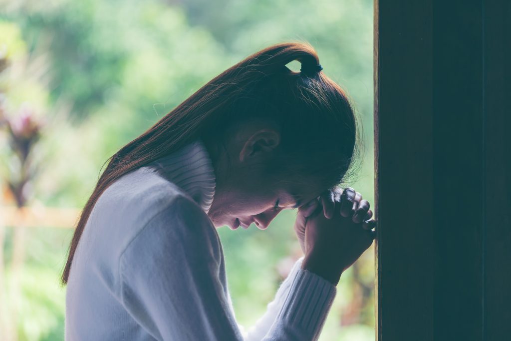 Religion, faith and people concept. Woman Pray for god blessing to wishing have a better life. begging for forgiveness and believe in goodness. Christian life crisis prayer to god.