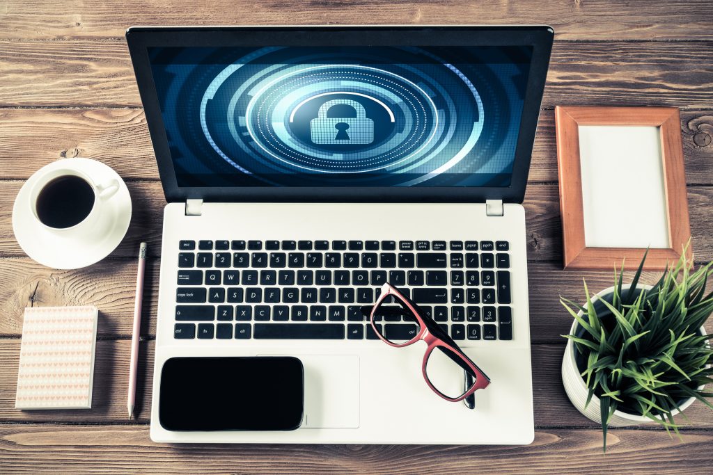 Business workplace with office stuff and laptop with padlock icons on screen