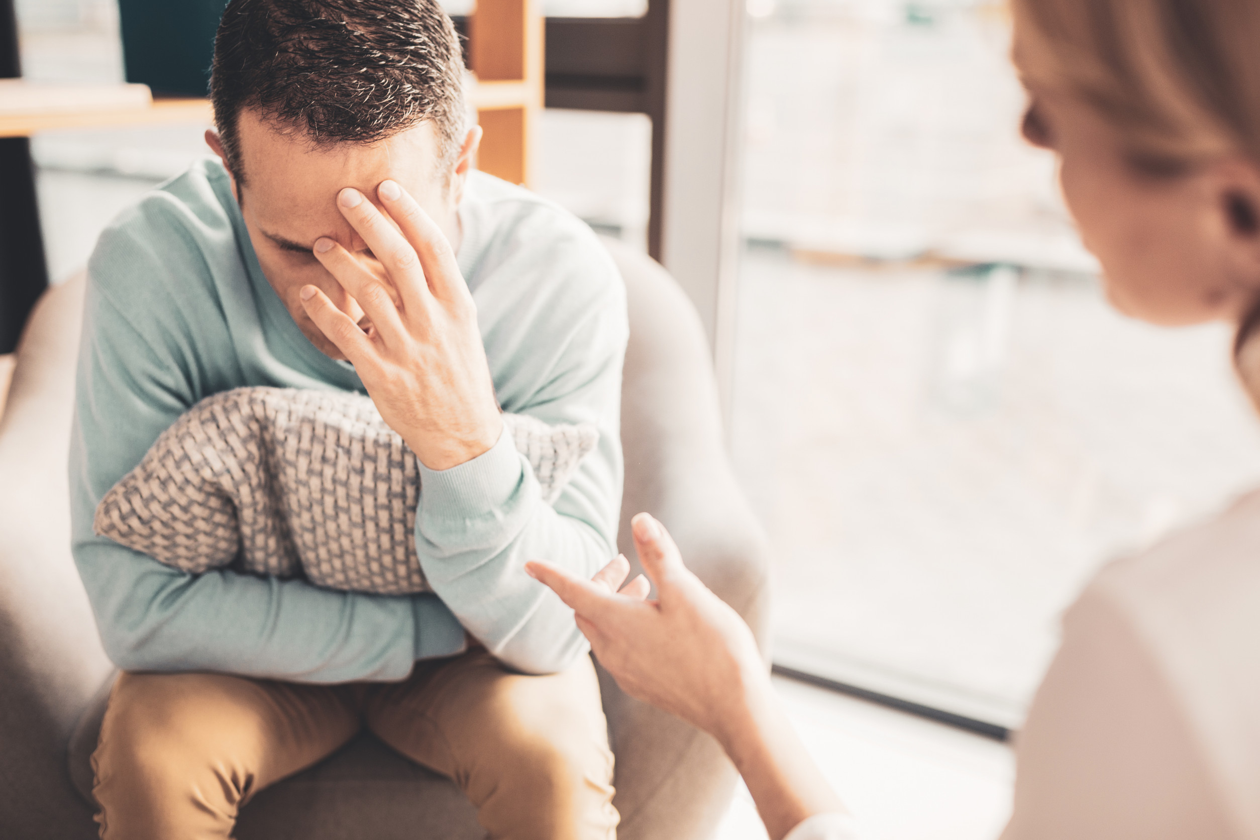 Overloaded man. Stressed worried man feeling overloaded after busy workday at his successful company