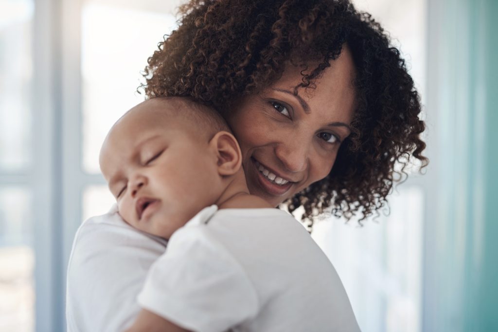 Time stops when a baby sleeps. an adorable baby girl sleeping peacefully in her mothers arms at home